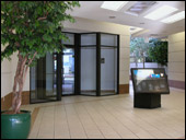 Interior photo shows a handsome office center entrance and office directory signage